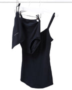 A black strappy vest and pants set hanging on a rail. 